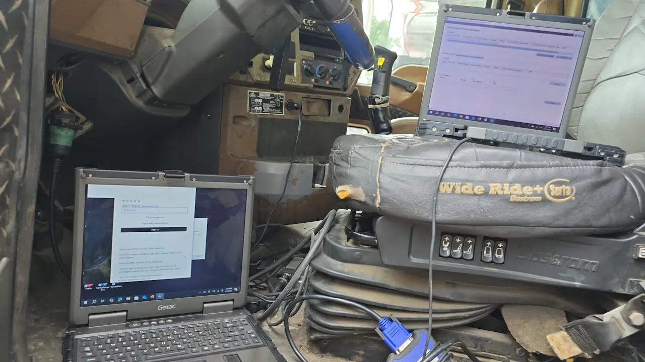 Diagnostic laptops connected to a truck in the shop